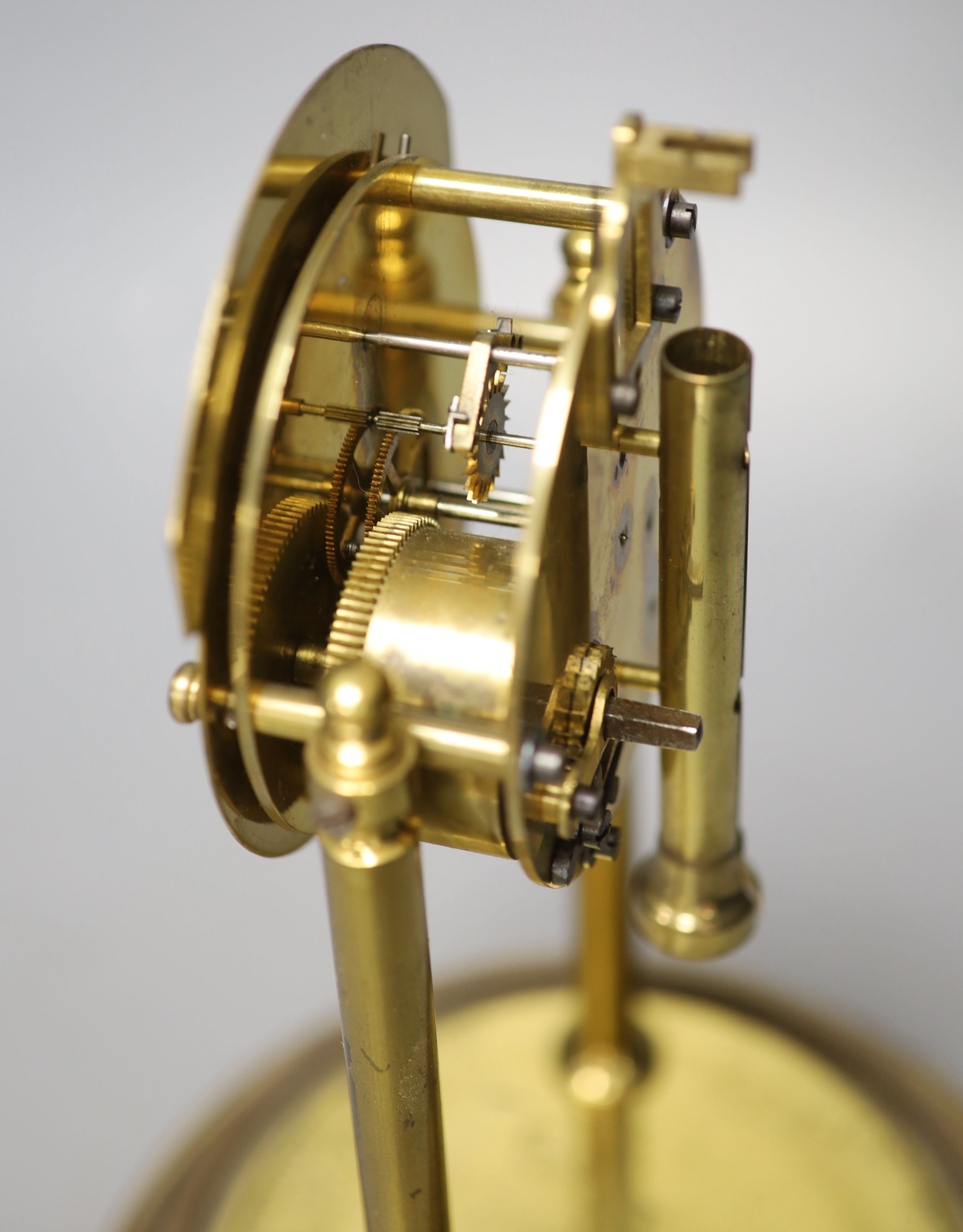 A brass electric mantel clock, under a glass dome, overall height 30cm